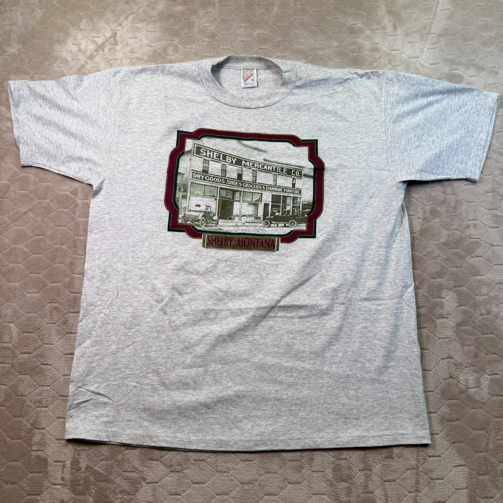 VTG Shelby Mercantile Shelby, Montana Shirt Sz XL USA‎ Made DS Glitter Print